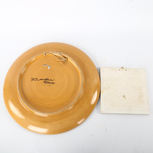 55 - A 1950s' Ruffinelli Assisi wall hanging platter and an Italian wall hanging tile, platter diameter 3... 