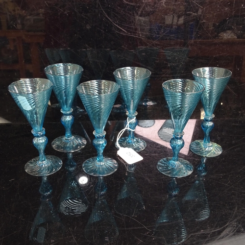 352 - A set of 6 Wrythen blue glass goblets, H 13cm. 1 A/F