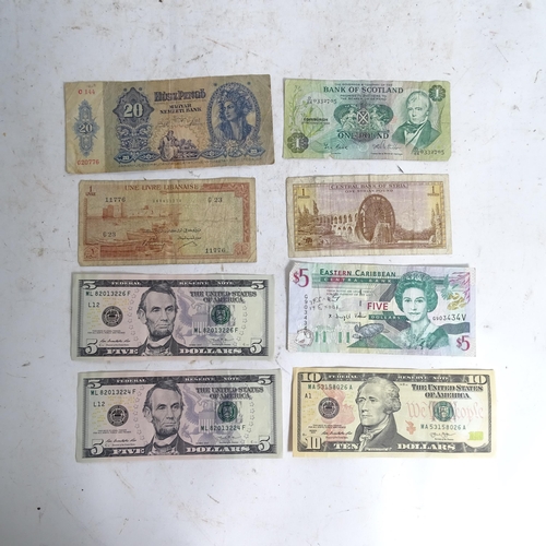 122 - A collection of various world banknotes, including American dollars, Indian, Trinidad and Tobago etc... 