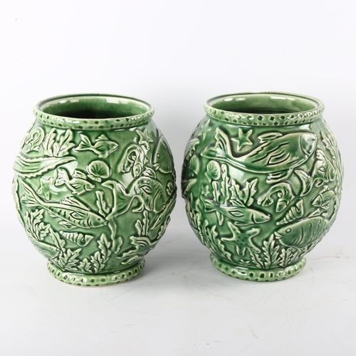 176 - A pair of French green glaze pottery vases, with relief moulded under-sea decoration, height 21cm