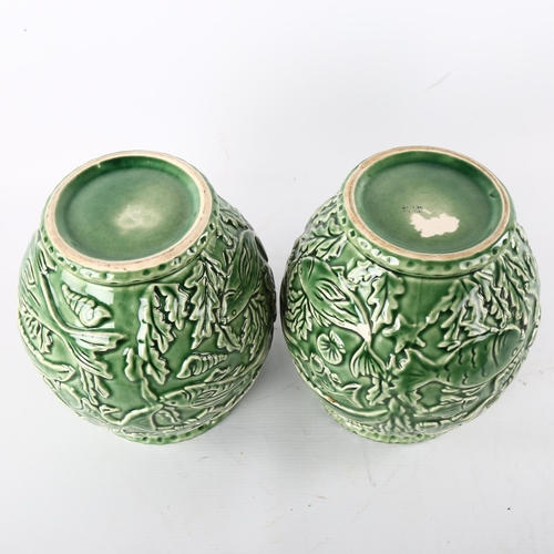 176 - A pair of French green glaze pottery vases, with relief moulded under-sea decoration, height 21cm