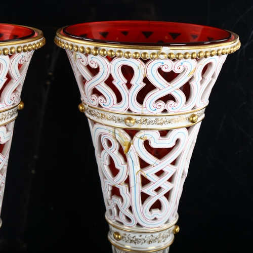 182 - A pair of late 19th century pierced white glaze porcelain vases, with gilded decoration and cranberr... 