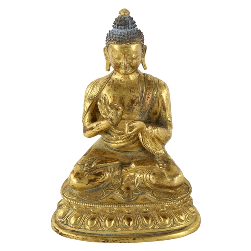 211 - A Chinese gilt-bronze seated Buddha, height 15cm