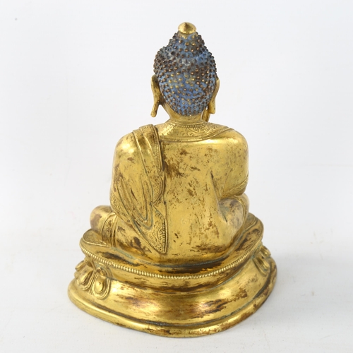 211 - A Chinese gilt-bronze seated Buddha, height 15cm