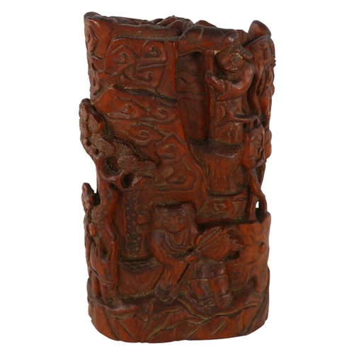 212 - A Chinese relief carved and stained wood ornament, decorated with figures, height 17cm