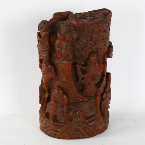 212 - A Chinese relief carved and stained wood ornament, decorated with figures, height 17cm