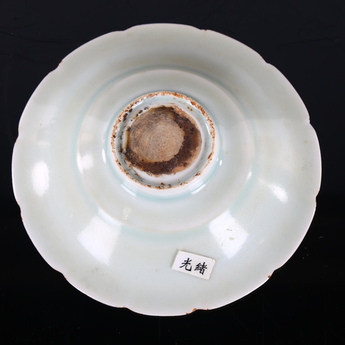 216 - A small Chinese celadon glaze bowl with relief moulded fish design, diameter 15cm