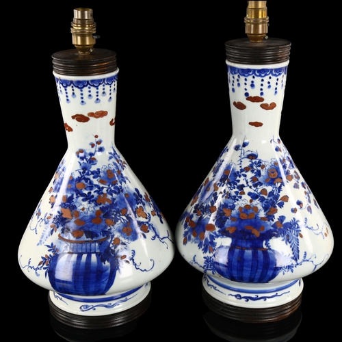 219 - A pair of Chinese blue and white porcelain table lamps, with hand painted and gilded decoration, hei... 