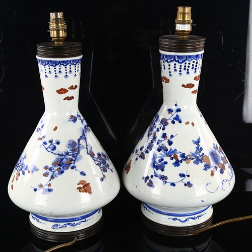 219 - A pair of Chinese blue and white porcelain table lamps, with hand painted and gilded decoration, hei... 