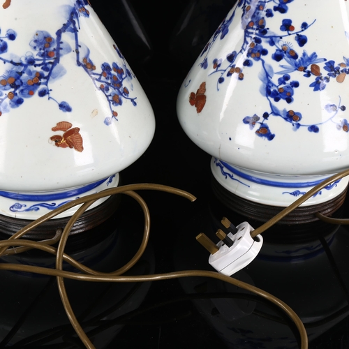 219 - A pair of Chinese blue and white porcelain table lamps, with hand painted and gilded decoration, hei... 