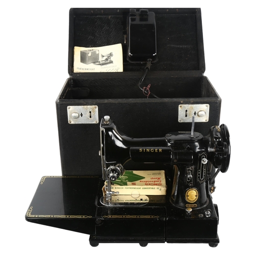 241 - An early portable Singer sewing machine, model 222K, in original box with papers and accessories