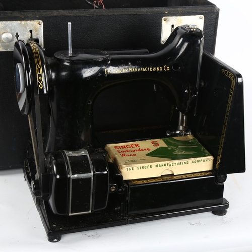 241 - An early portable Singer sewing machine, model 222K, in original box with papers and accessories