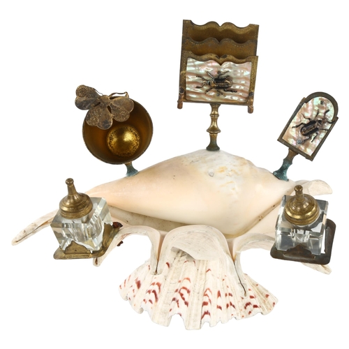 242 - A novelty conch shell desk stand, surmounted by brass inkwells, mother-of-pearl mounted matchbox hol... 