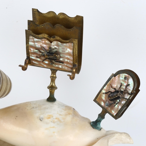 242 - A novelty conch shell desk stand, surmounted by brass inkwells, mother-of-pearl mounted matchbox hol... 