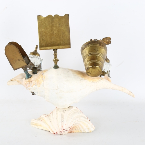 242 - A novelty conch shell desk stand, surmounted by brass inkwells, mother-of-pearl mounted matchbox hol... 