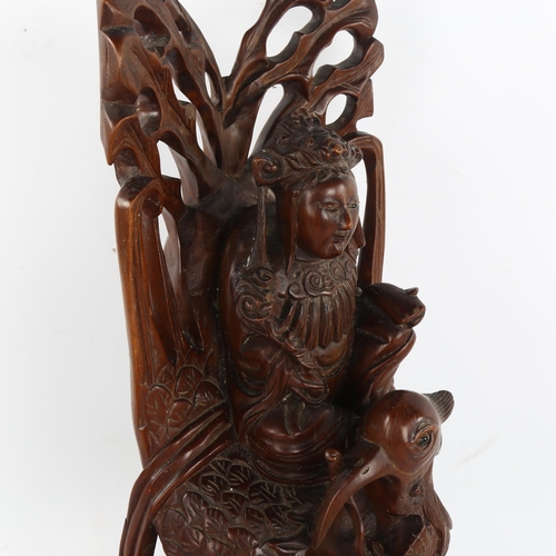 246 - A Chinese carved and stained wood figure riding a bird, height 38cm