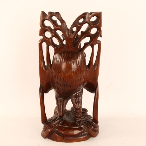 246 - A Chinese carved and stained wood figure riding a bird, height 38cm