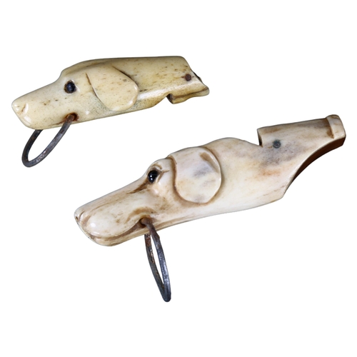 279 - 2 x 19th century carved bone dog's head design whistles with glass eyes, largest length 6.5cm