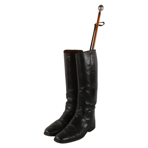 303 - A 1946 silver topped Devonshire Regiment swagger stick, a pair of military leather boots and a horse... 