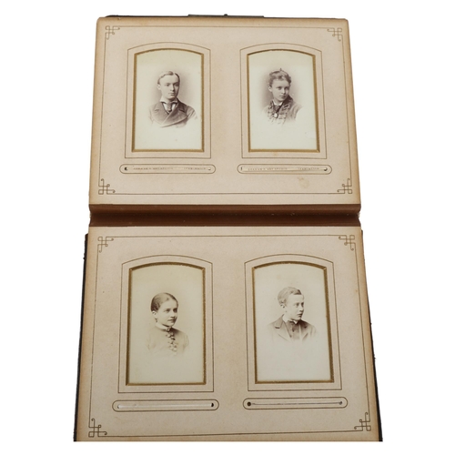 305 - A Victorian photo album with cushioned leather bound cover,  22 x 18cm