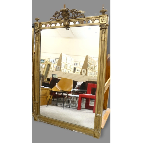 164 - A 19th century gilt composition framed pier glass mirror, with mask decorated pediment and fluted sp... 