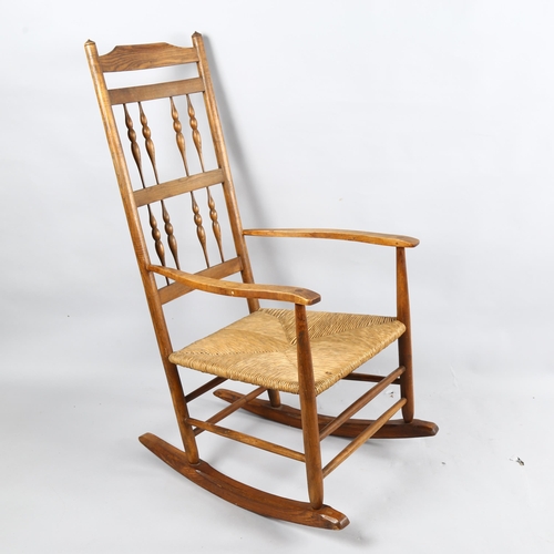 179 - Neville Neal, an Arts and Crafts Cotswold School Ernest Gimson design spindle back rocking chair in ... 