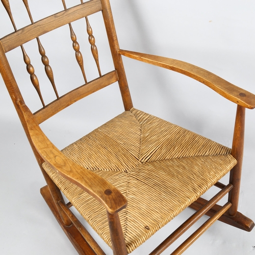 179 - Neville Neal, an Arts and Crafts Cotswold School Ernest Gimson design spindle back rocking chair in ... 