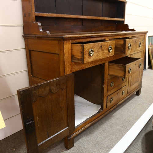 235 - George III oak Welsh dresser, with boarded open plate rack, and drawers and cupboards below, width 1... 