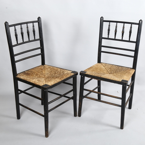 256 - A pair of Morris & Company, Arts and Crafts spindle back ebonised Sussex chairs with rush seats, hei... 