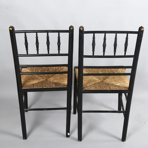 256 - A pair of Morris & Company, Arts and Crafts spindle back ebonised Sussex chairs with rush seats, hei... 