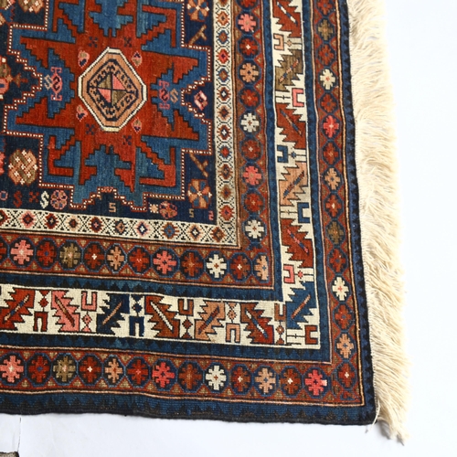 191 - A early 19th century north-eastern Caucuses Lesghistan carpet with three Lesghi 8 pointed medallions... 