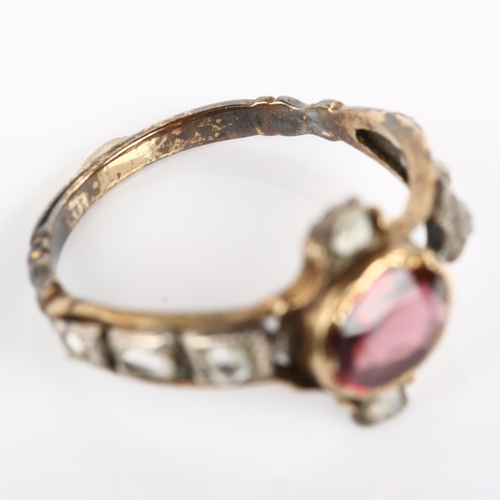 1054 - A Georgian garnet and diamond ring, unmarked gold settings with oval mixed-cut garnet and rose-cut d... 