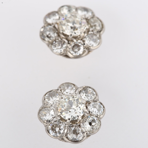 1056 - A pair of diamond cluster flowerhead earrings, unmarked white gold settings with old European and mo... 