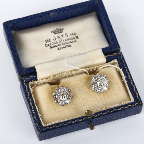 1056 - A pair of diamond cluster flowerhead earrings, unmarked white gold settings with old European and mo... 
