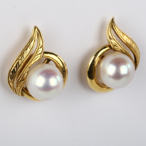 1087 - A pair of whole pearl earrings, unmarked gold settings with screw-back fittings, earring height 16.2... 