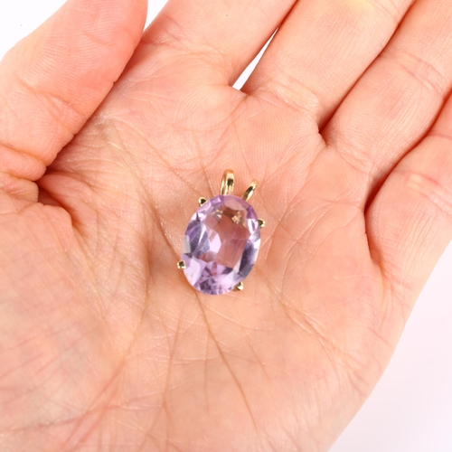 1093 - A 14ct gold amethyst pendant, prong set with oval mixed-cut amethyst, pendant height 23.5mm, 4.2g