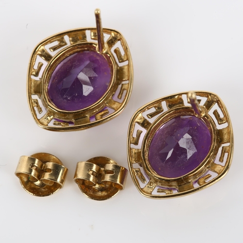 1098 - A pair of amethyst earrings, unmarked gold Greek Key design with oval mixed-cut amethyst, earring he... 