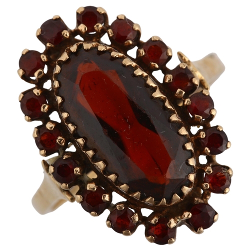 1103 - A 9ct gold garnet cluster ring set with oval and round-cut garnets, setting height 21.2mm, size P, 3... 