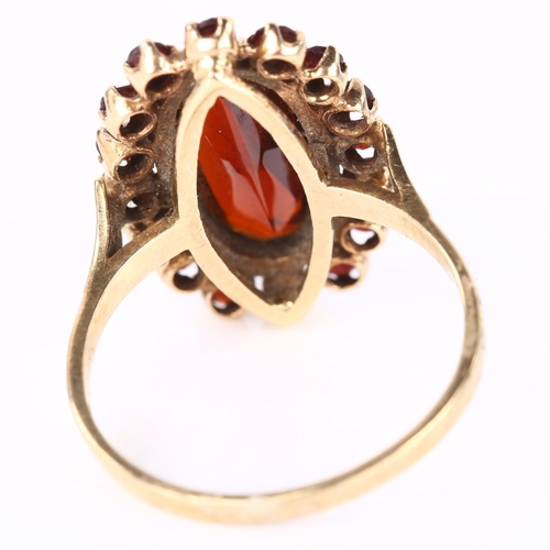 1103 - A 9ct gold garnet cluster ring set with oval and round-cut garnets, setting height 21.2mm, size P, 3... 