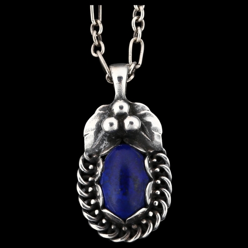 1231 - GEORG JENSEN - a Danish stylised sterling silver and lapis lazuli pendant necklace of the year 1992,... 