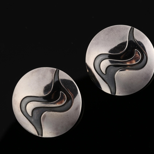 1238 - NIELS ERIK FROM - a pair of Danish sterling silver and niello abstract disc earrings, with clip fitt... 