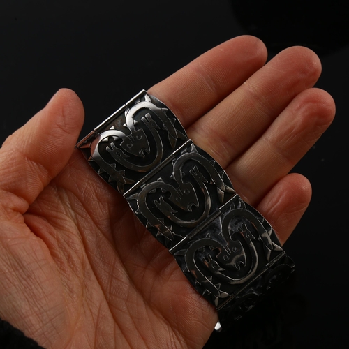 1239 - A Scandinavian sterling silver Viking Revival design panel bracelet, with mythological creatures, br... 