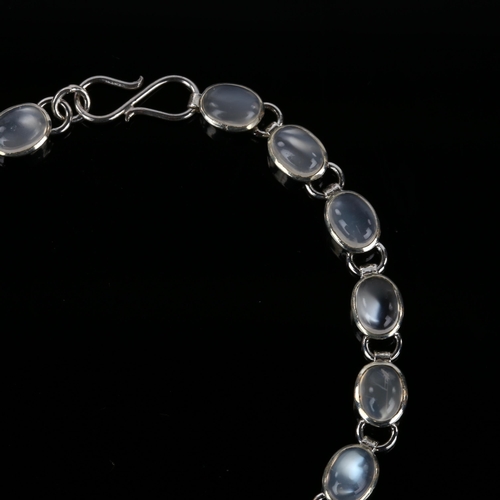 1255 - A silver moonstone line bracelet, set with oval cabochon moonstone, bracelet length 18.5cm, 9.3g