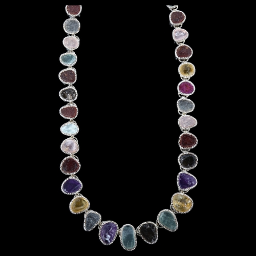 1256 - A silver gem set fringe necklace, set with rough-cut gemstones, including amethyst citrine topaz rub... 