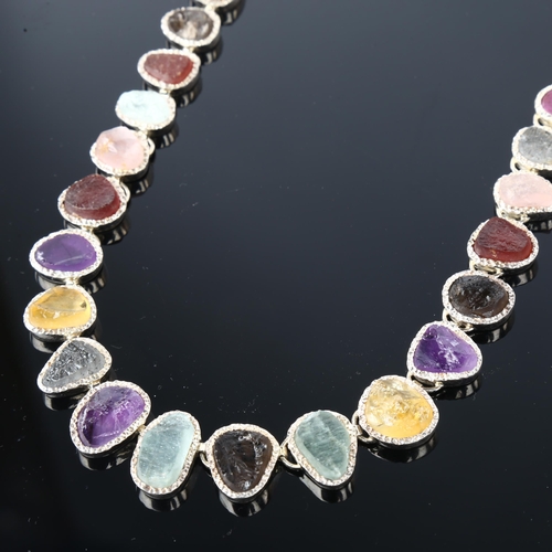 1256 - A silver gem set fringe necklace, set with rough-cut gemstones, including amethyst citrine topaz rub... 