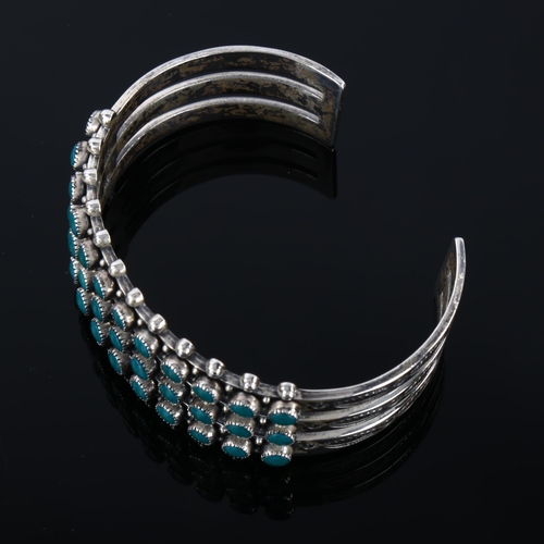 1286 - A Native American Navajo sterling silver and turquoise cuff bracelet, band width 23.5mm, internal ci... 