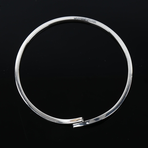 1287 - MICHAEL KARVANY - a Danish sterling silver plain form crossover bangle, band width 2.8mm, internal c... 