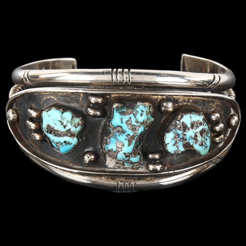 1289 - A heavy Native American Navajo turquoise cuff bracelet, unmarked silver settings, setting height 35.... 