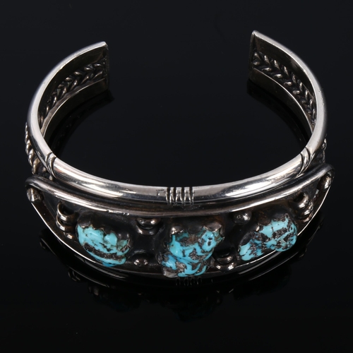 1289 - A heavy Native American Navajo turquoise cuff bracelet, unmarked silver settings, setting height 35.... 