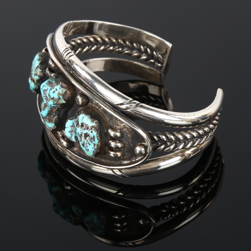 1289 - A heavy Native American Navajo turquoise cuff bracelet, unmarked silver settings, setting height 35.... 